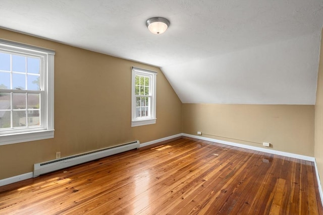 4 Hadwen Rd, Worcester, MA 01602 - additional living space featuring baseboard heating, vaulted ceiling, hardwood / wood-style floors, and baseboards