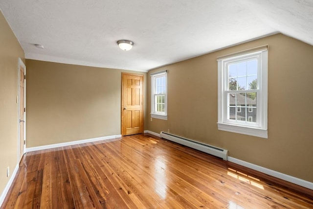 4 Hadwen Rd, Worcester, MA 01602 - empty room featuring baseboard heating, wood-type flooring, baseboards, a smoke detector, and vaulted ceiling