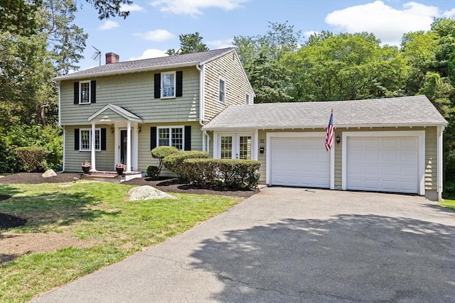 32 Gannett Pasture Ln, Scituate, MA 02066 - colonial-style house featuring a chimney, driveway, an attached garage, a front yard, and a shingled roof