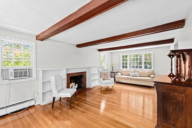 32 Gannett Pasture Ln, Scituate, MA 02066 - living area featuring baseboard heating, wood finished floors, beam ceiling, cooling unit, and a brick fireplace