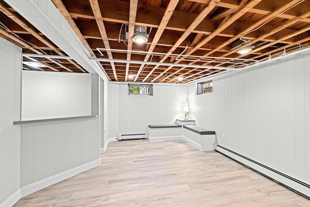 32 Gannett Pasture Ln, Scituate, MA 02066 - below grade area with a baseboard heating unit, a baseboard radiator, and light wood-type flooring