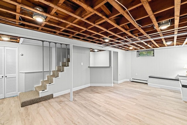 32 Gannett Pasture Ln, Scituate, MA 02066 - basement with wood finished floors, baseboard heating, and stairs