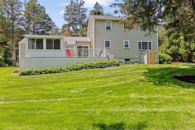 32 Gannett Pasture Ln, Scituate, MA 02066 - rear view of house with a storage unit, a lawn, a wooden deck, and a sunroom