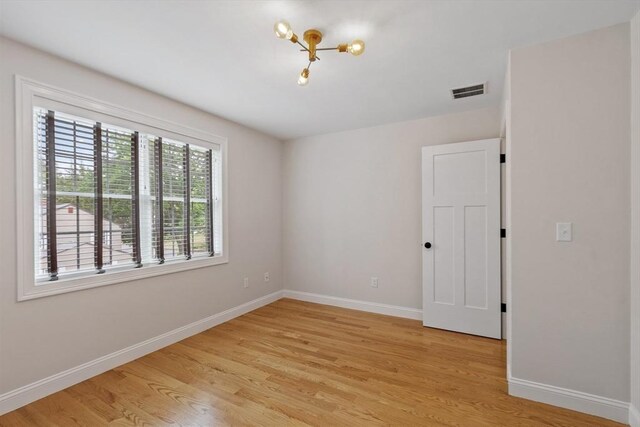 35 Lucaya Cir, Wilmington, MA 01887 - unfurnished room with baseboards, light wood finished floors, and a chandelier