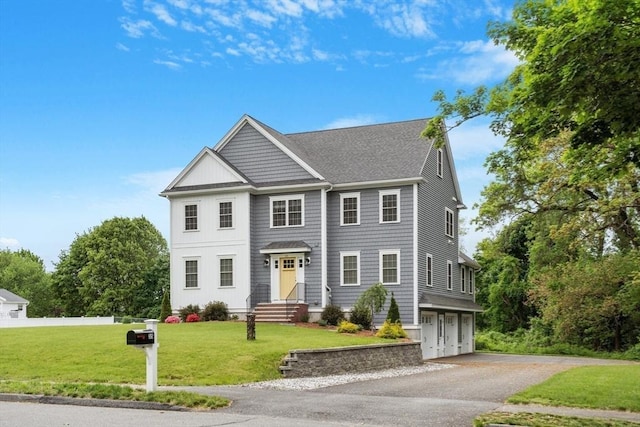 35 Lucaya Cir, Wilmington, MA 01887 - view of front of house featuring an attached garage, a shingled roof, driveway, and a front lawn
