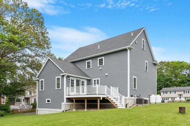 35 Lucaya Cir, Wilmington, MA 01887 - back of house featuring a deck, a yard, cooling unit, and a shingled roof