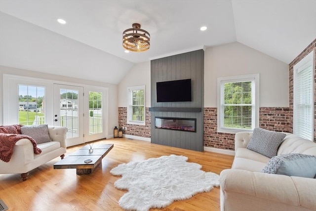 35 Lucaya Cir, Wilmington, MA 01887 - living area with lofted ceiling, a large fireplace, brick wall, light wood-style floors, and recessed lighting