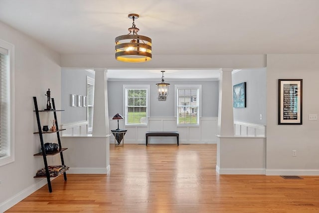 35 Lucaya Cir, Wilmington, MA 01887 - dining space featuring ornate columns, light wood-style flooring, and a chandelier