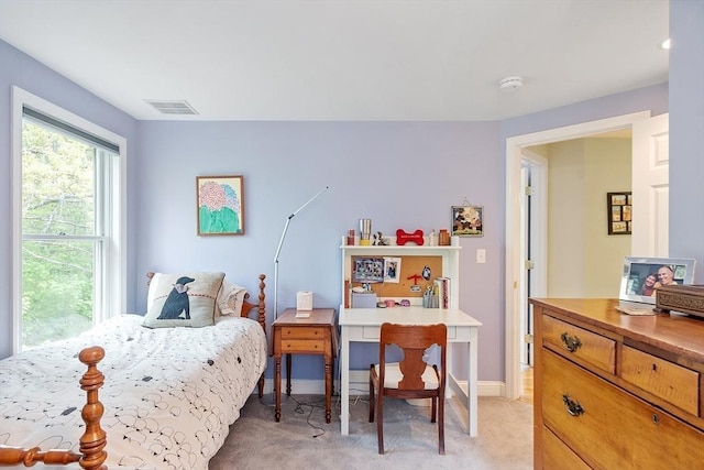 bedroom with light colored carpet and baseboards