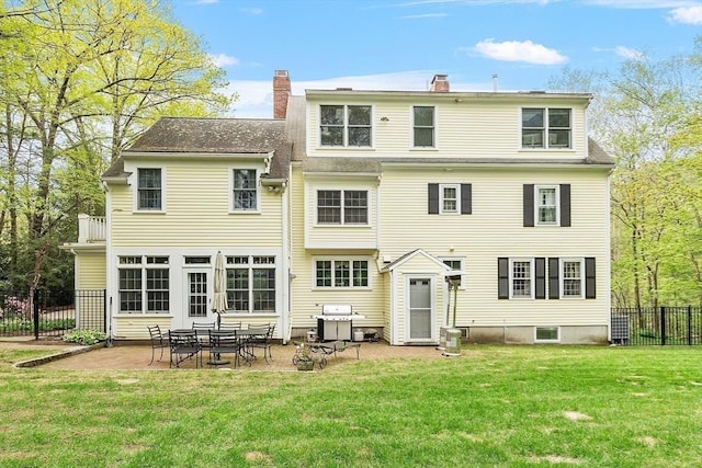 back of house featuring a chimney and a patio area