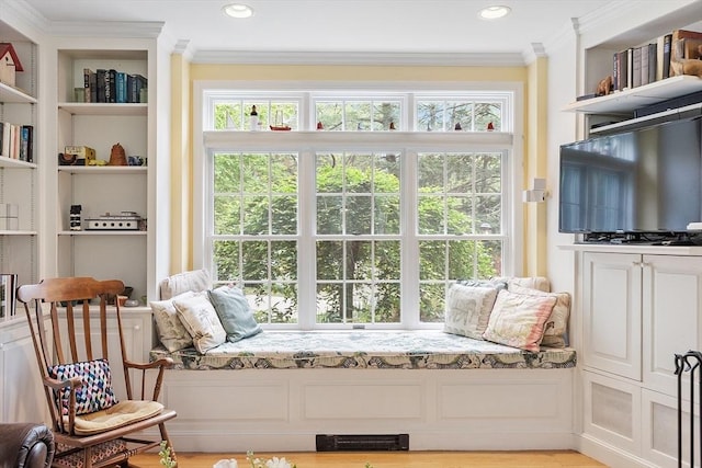 sitting room featuring ornamental molding, plenty of natural light, recessed lighting, and built in features
