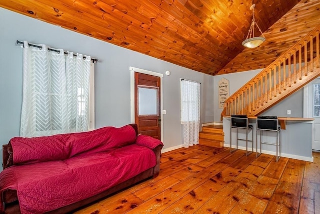 living room featuring lofted ceiling, plenty of natural light, wood-type flooring, and wooden ceiling