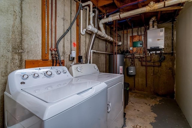 clothes washing area featuring water heater, washer and clothes dryer, and tankless water heater