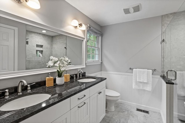 21 Mcdonough Dr, Marlborough, MA 01752 - full bath featuring a shower stall, marble look tiles, toilet, double vanity, and wainscoting