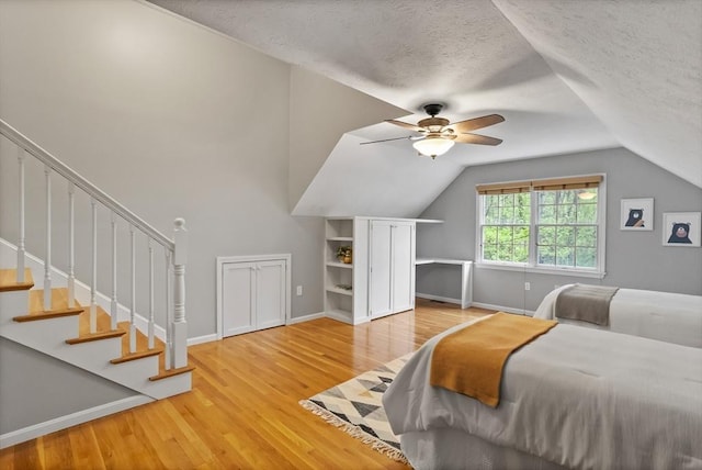 21 Mcdonough Dr, Marlborough, MA 01752 - bedroom featuring wood finished floors, vaulted ceiling, baseboards, ceiling fan, and a textured ceiling