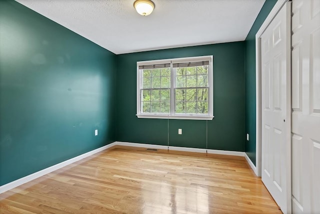 21 Mcdonough Dr, Marlborough, MA 01752 - unfurnished bedroom with light wood-style flooring, baseboards, and a closet