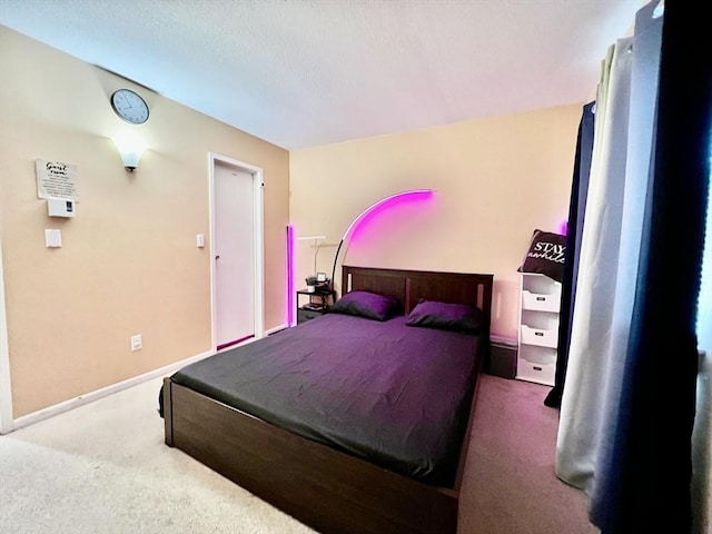 bedroom featuring baseboards and carpet
