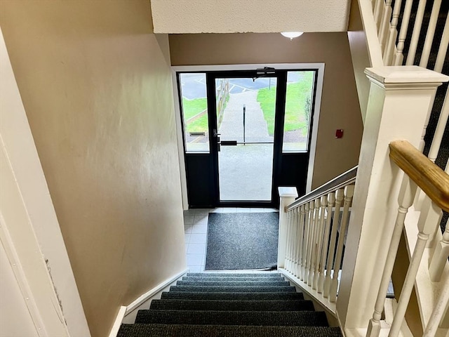 stairs with tile patterned flooring
