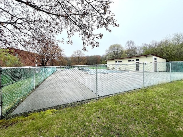 view of swimming pool with fence and a tennis court