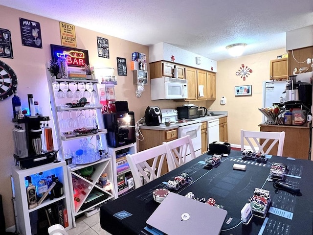 game room featuring light tile patterned floors and a textured ceiling