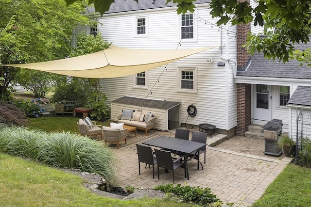 back of property featuring an outdoor living space, roof with shingles, a patio area, and entry steps