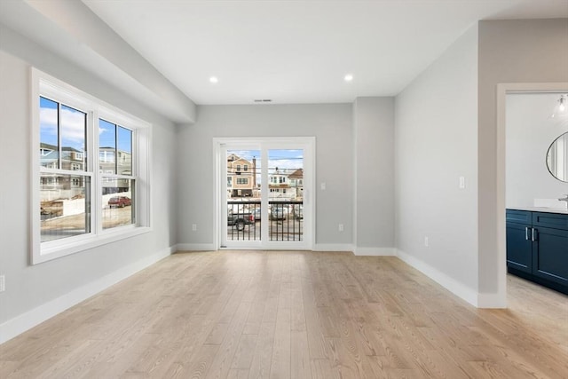 unfurnished room featuring light wood-style flooring, baseboards, and recessed lighting