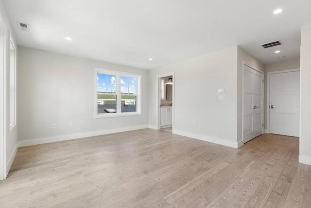 spare room with recessed lighting, baseboards, visible vents, and light wood finished floors