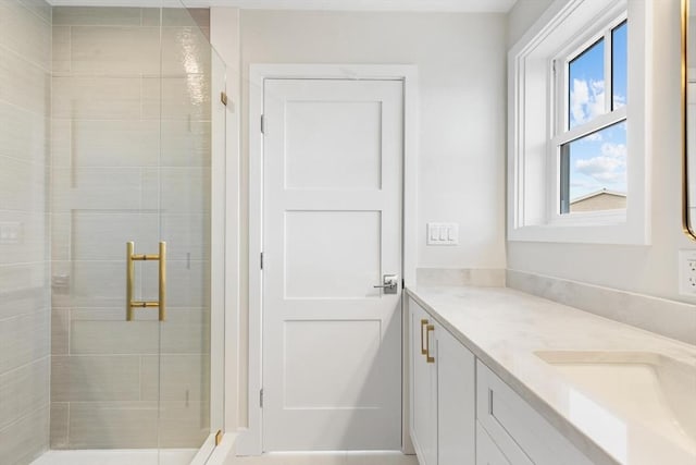 bathroom featuring a shower stall and vanity