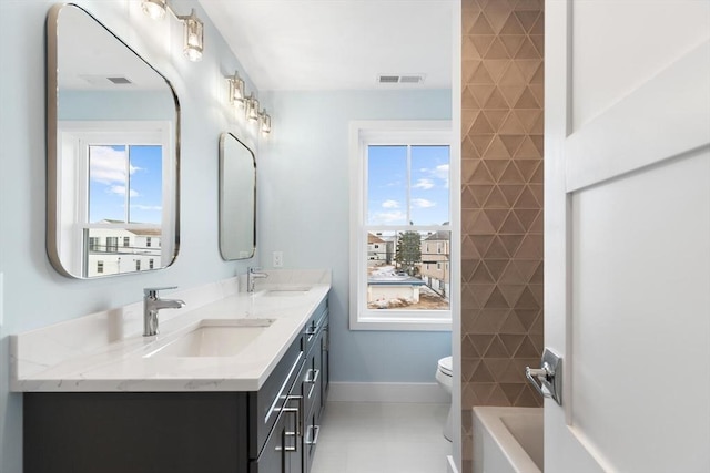 bathroom with toilet, visible vents, and a sink