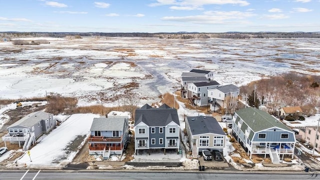 snowy aerial view featuring a residential view