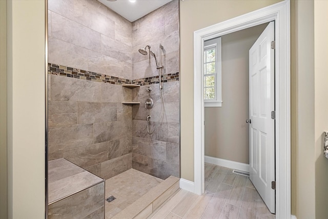 bathroom with a tile shower