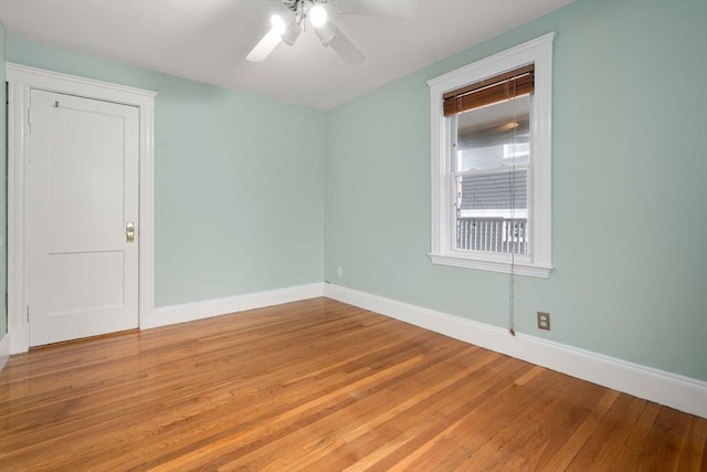 empty room with baseboards, light wood-style flooring, and a ceiling fan