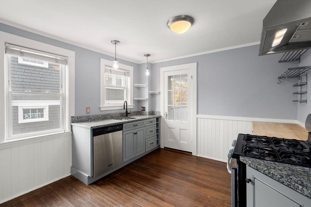 kitchen featuring a sink, wall chimney exhaust hood, dark wood finished floors, wainscoting, and appliances with stainless steel finishes