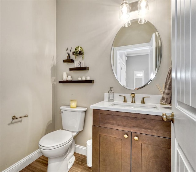 bathroom featuring hardwood / wood-style flooring, vanity, and toilet