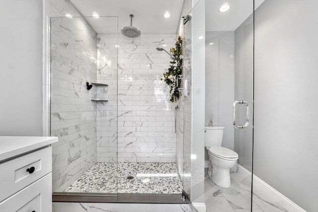 bathroom with an enclosed shower, vanity, and toilet