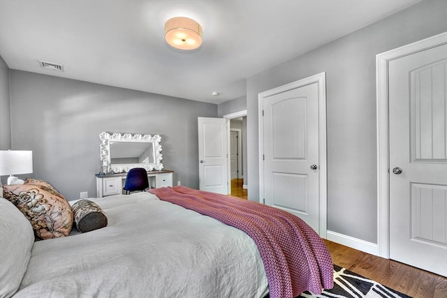 bedroom with hardwood / wood-style flooring