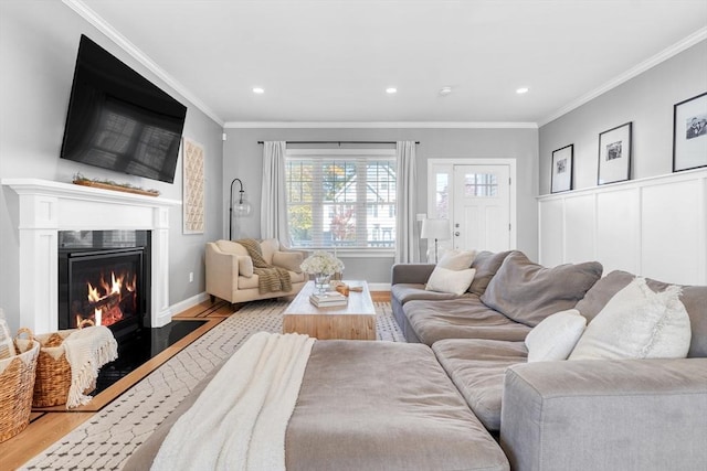 living room with crown molding and light hardwood / wood-style flooring