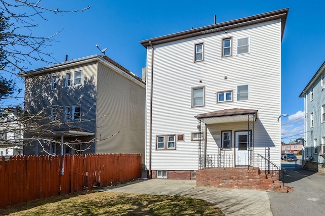 back of house featuring a patio and fence