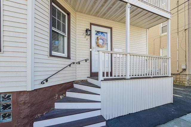 view of exterior entry featuring a porch