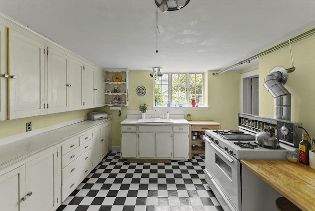 38 Booth Hill Rd, Scituate, MA 02066 - kitchen featuring white gas range, tile patterned floors, light countertops, open shelves, and white cabinetry