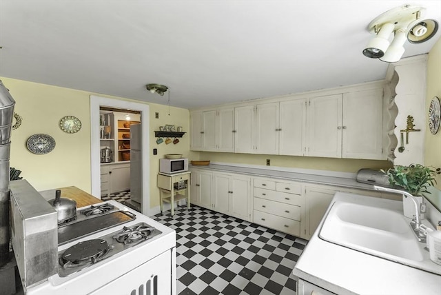 38 Booth Hill Rd, Scituate, MA 02066 - kitchen with gas range oven, tile patterned floors, light countertops, and freestanding refrigerator
