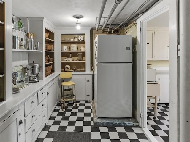 38 Booth Hill Rd, Scituate, MA 02066 - kitchen featuring freestanding refrigerator, dark flooring, light countertops, open shelves, and white cabinetry