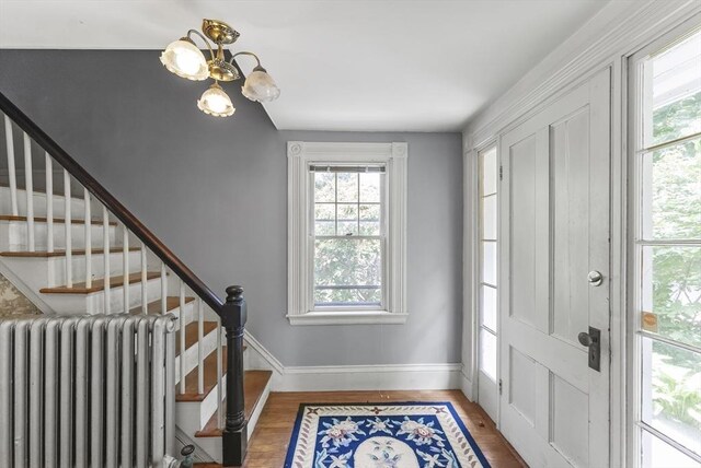 38 Booth Hill Rd, Scituate, MA 02066 - entrance foyer featuring radiator heating unit, a chandelier, stairs, and wood finished floors