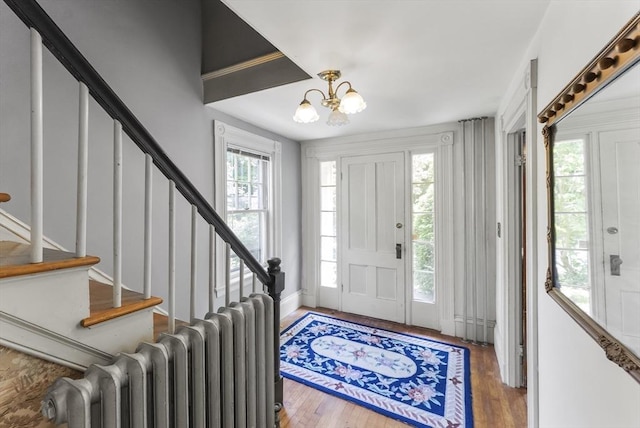 38 Booth Hill Rd, Scituate, MA 02066 - entrance foyer with radiator, a chandelier, stairway, and wood finished floors