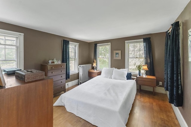 38 Booth Hill Rd, Scituate, MA 02066 - bedroom featuring radiator, multiple windows, and wood finished floors