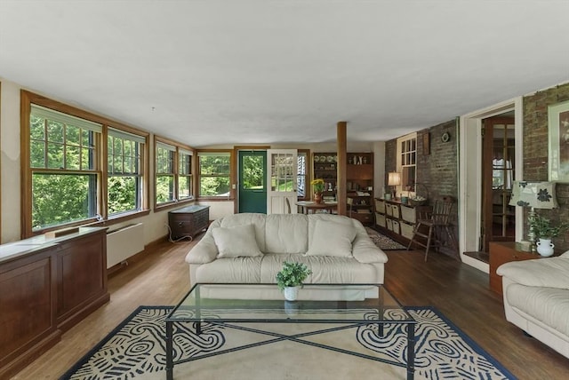 38 Booth Hill Rd, Scituate, MA 02066 - living room with wood finished floors, brick wall, and radiator