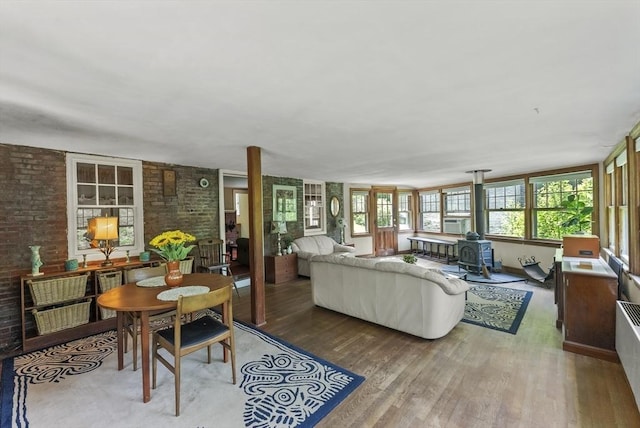 38 Booth Hill Rd, Scituate, MA 02066 - living area featuring a wood stove, brick wall, and wood finished floors
