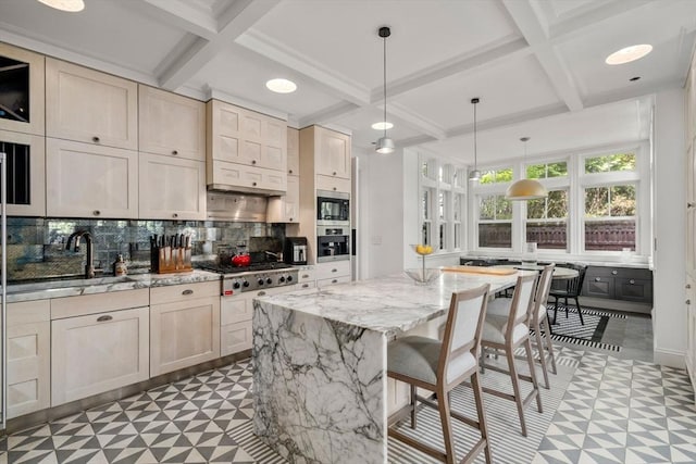 kitchen with tile patterned floors, coffered ceiling, stainless steel appliances, tasteful backsplash, and light stone countertops