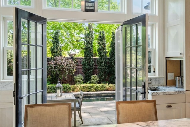 doorway to outside featuring a sink and tile patterned floors