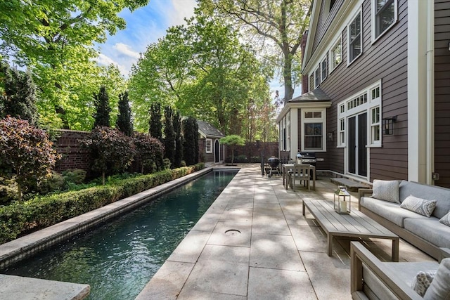 view of pool with an outdoor hangout area, a patio, an outdoor structure, a fenced backyard, and outdoor dining space